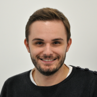 Michael Wolz - Head of Development: Smiling man with dark brown eyes, black beard and short brown hair.
