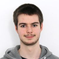 Simon Berz - Cloud Engineer: Smiling man with black, short hair; dark brown eyes and short, dark brown beard.